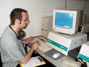 A man analyzing data at a computer.